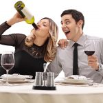 Couple drinking wine from a bottle