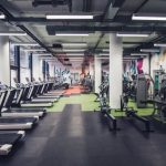 Large group of exercise machines in an empty gym.